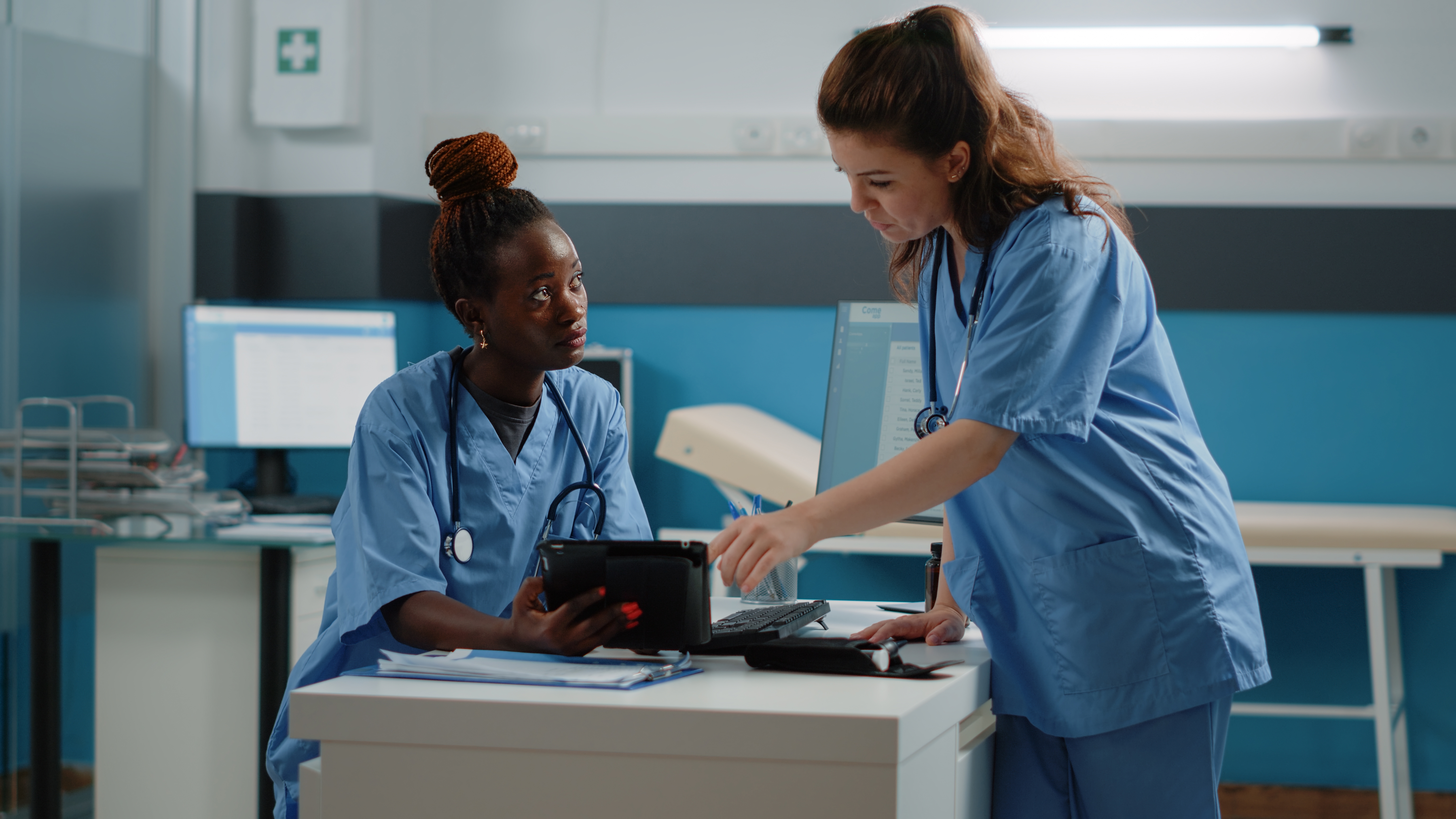 2 female healthcare professionals working with laptop